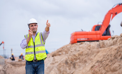 Surveyor engineer wearing safety uniform and helmet with equipment theodolite to measurement...