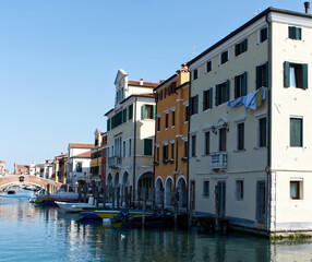 Fototapeta na wymiar Canals and bridges of Chioggia. This small town is known as The Little Venice of Italy.