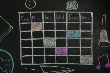 Weekly school timetable drawn with colorful chalk on blackboard