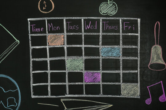 Weekly school timetable drawn with colorful chalk on blackboard