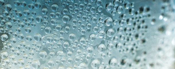 Many Water Rain Drops wet window condensation on glass. Fresh background. Textures formed by bubbles. Collection clear surface. Abstract real photo beautiful romantic cute wallpaper. Colour light blue