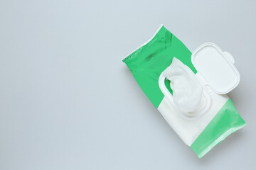 Wet wipes flow pack on light grey background, top view. Space for text