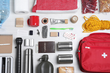 Disaster supply kit for earthquake on white wooden table, flat lay