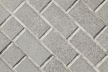 Pavement with grey tiles as background, top view