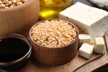 Different organic soy products on wooden board, closeup