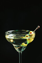 Martini cocktail with olives on dark background, closeup. Space for text