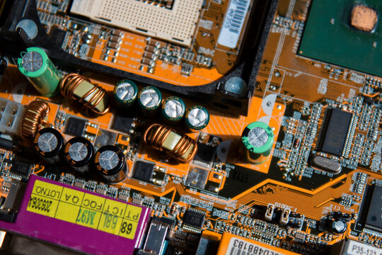 Yellow circuit board background of PC computer motherboard. Yellow Electronic system computer motherboard, digital chip, transistor, microcircuit, socket, PCI, AGP. Inside details of the old PC
