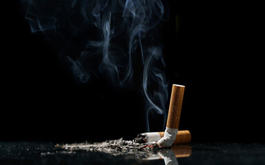 Tobacco cigarette Butt on the Floor in dark background for world Tobacco day concept or stop smoking
