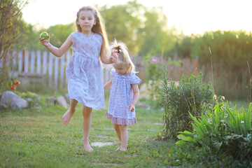 Fototapeta premium Children walk in the summer in nature. Child on a sunny spring morning in the park. Traveling with children.