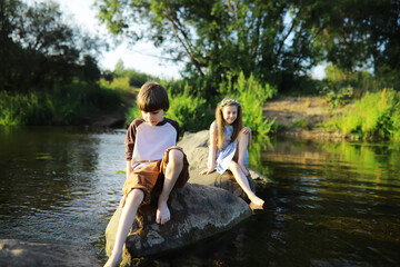 Children walk in the summer in nature. Child on a sunny spring morning in the park. Traveling with children.