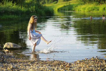 Children walk in the summer in nature. Child on a sunny spring morning in the park. Traveling with children.