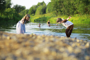 Children walk in the summer in nature. Child on a sunny spring morning in the park. Traveling with children.