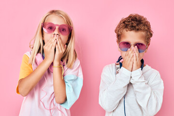 Portrait of a girl and a boy blonde hair fashionable glasses Childhood lifestyle concept