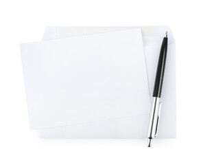 Envelope with blank letter and pen on white background, top view