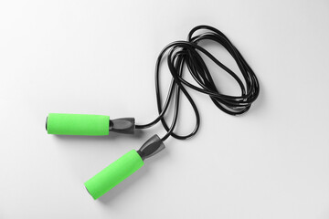 Skipping rope on white background, top view. Sports equipment