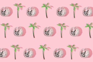 Summer creative pattern with  disco ball decoration and palm tree figurine on pastel pink background. 80s or 90s retro fashion aesthetic party concept. Minimal summer pop art idea.