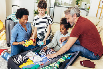 Obraz premium Happy family having great time and packing for summer holidays