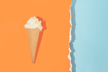 Summer creative layout with ice cream cone and bright orange and pastel blue background.  70s, 80s...