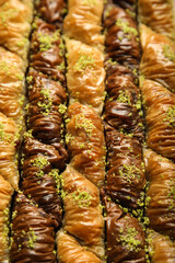 Delicious sweet baklava with pistachios as background, closeup view