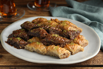 Delicious baklava with pistachios on wooden table