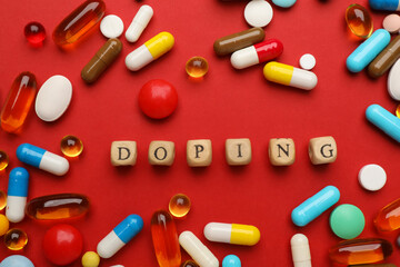 Flat lay composition with word Doping and drugs on red background