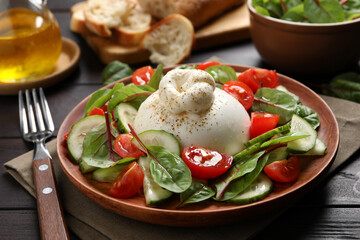 Delicious burrata salad served on wooden table