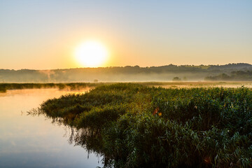 Fog above the water surface. Sunrise at river