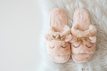 Fototapeta na wymiar Home slippers on a white fluffy carpet