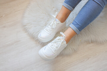 Woman wearing comfortable stylish sneakers indoors, closeup
