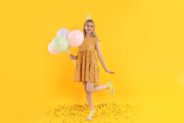 Concept of Happy Birthday with attractive girl on yellow background