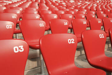 red rows of numbered empty seats in olympic sport stadium birds nest, Beijing, China