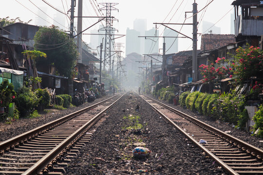 selective focus of double track jakarta electric railway with high office building background