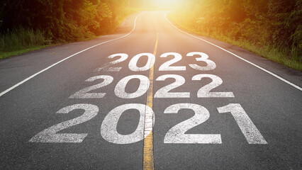 Direction to new year concept and sustainable development idea. Number of 2021 to 2023 on asphalt road surface with marking lines