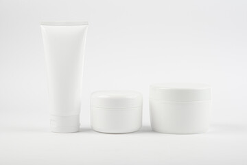 Set of three body creams, moisturizer on a white background