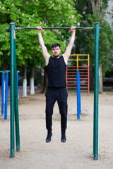 A male athlete is engaged in a horizontal bar