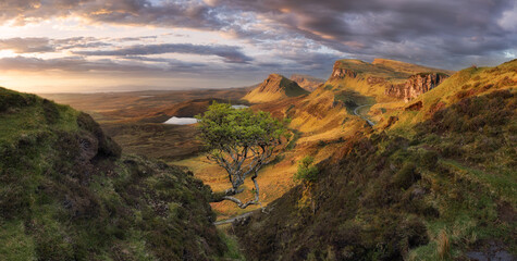 Scotland - Beautiful summer sunrise mountain landscape over the Quiraing and it's steep winding mountain road, on the Isle of Skye, UK