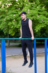 Male athlete doing an exercise on the uneven bars