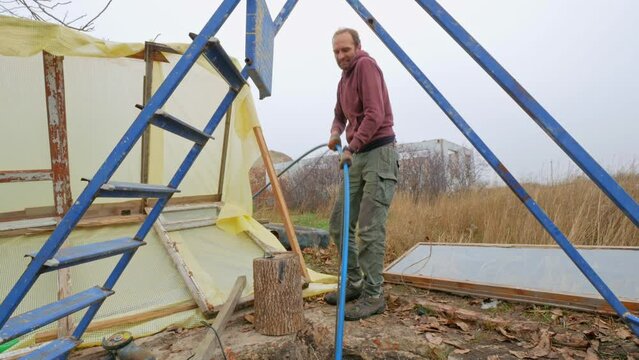 Man drills a well for artesian water in the garden