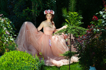 Beautiful woman in a long puffy dress in nature