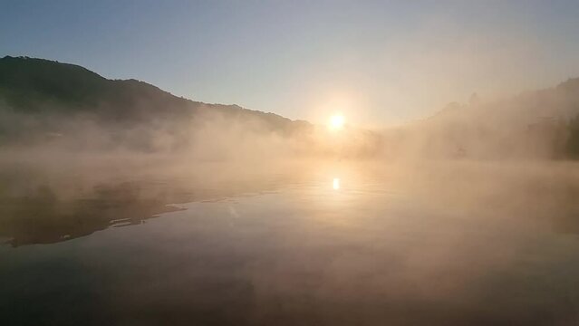misty lake the morning of the reservoir With yellow sunlight, Ban Rak Thai, Mae Hong Son, Thailand