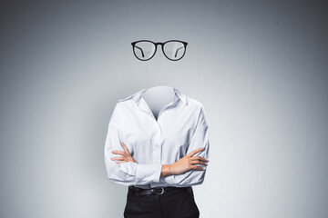 Headless invisible businesswoman with folded arms and abstract glasses standing on gray wall...