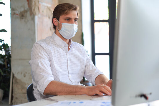 Businessman is working in preventive medical mask in office.