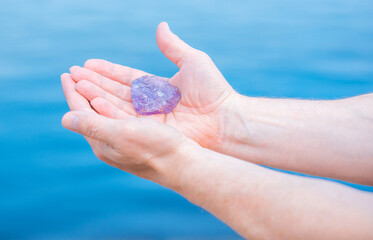 Quartz in hand, amethyst, alternative medicine. Energy therapy for mental healing