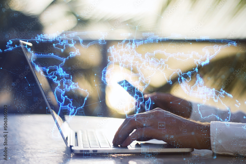 Poster Close up of hands using laptop and smartphone with glowing blue map hologram and digital data concept on blurry outdoor desktop background. Info, news and planet concept. Double exposure.