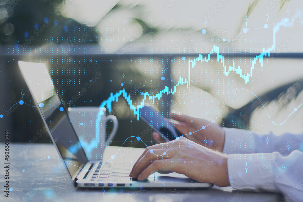 Poster hands using laptop and smartphone on desktop with coffee cup, growing forex chart and dot map on blu