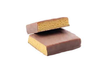 Protein bar with milk chocolate glaze. Pistachio flavor. Cut into two pieces. Close-up. White background. Isolated.