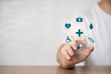 Man hand chooses a popup with emoticon icons healthcare medical symbol , Healthcare and medical Insurance for your concept