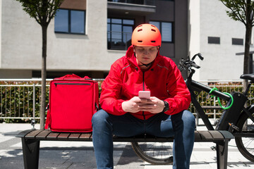 Delivery man checking food order with smartphone