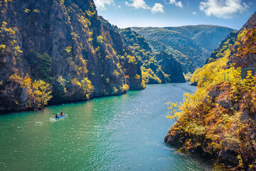 Aerial spring view of Matka Canyon with tourists on kayak. Majestic morning scene of North...