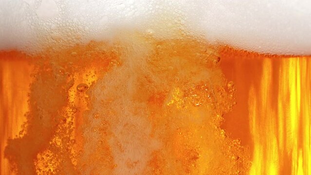Super Slow Motion Shot of Pouring Fresh Beer into Glass with Foam at 1000fps.